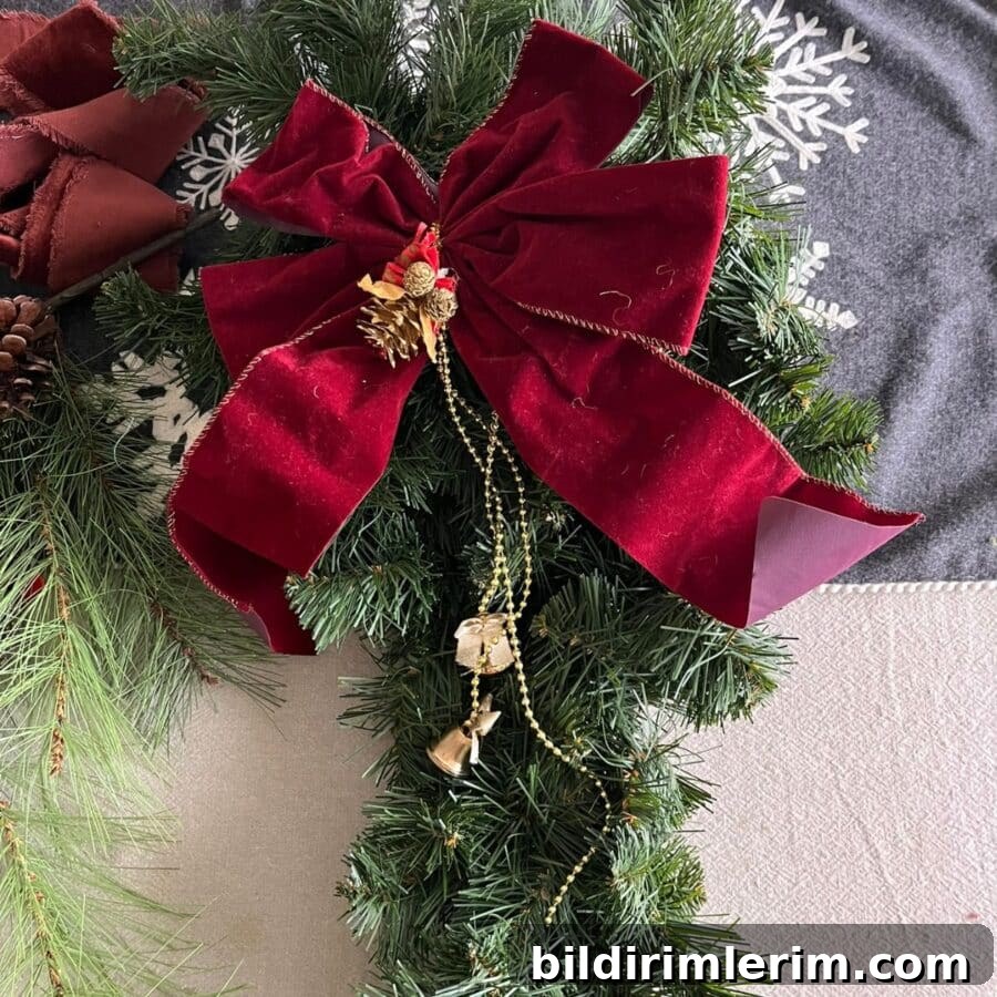 An outdated Christmas swag with old dusty ribbon and tacky gold beads and bells