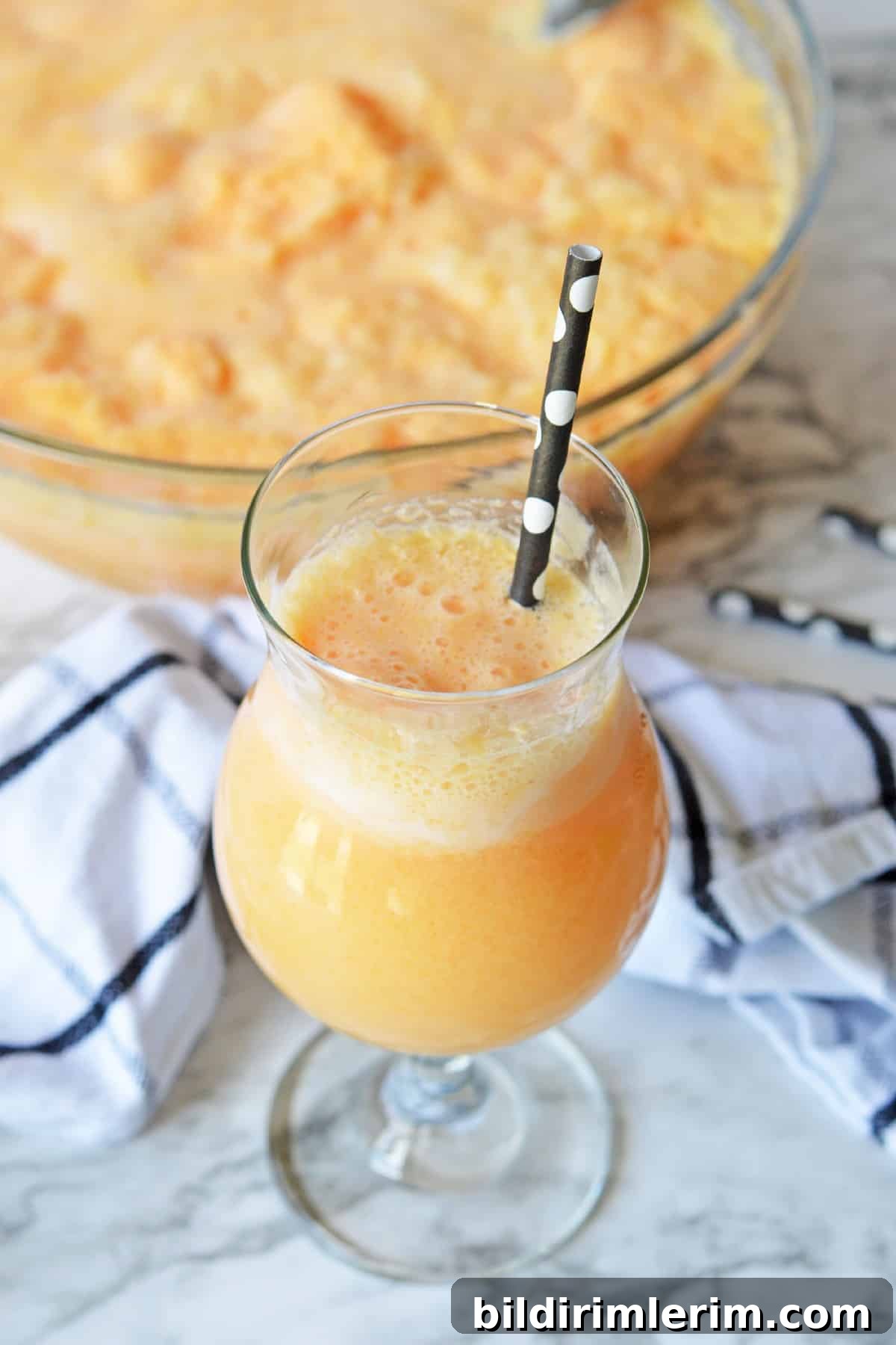 Festive Non-Alcoholic Punch Recipes for Holidays and Parties 4 Glass of orange sherbet punch beside a punch bowl
