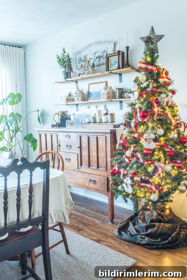 Christmas tree beside an antique buffet