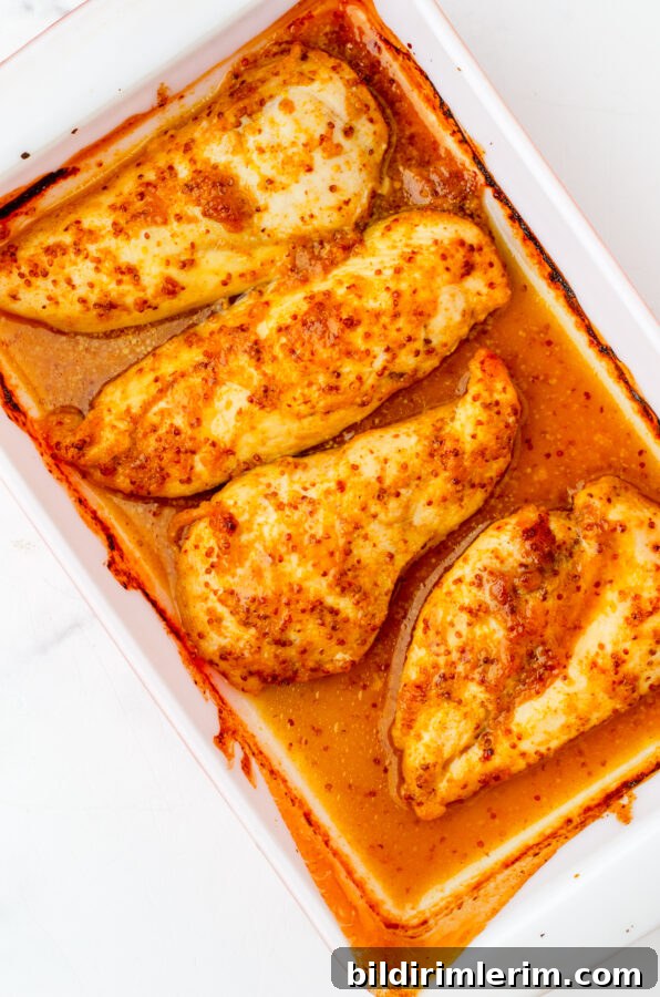 Baked honey mustard chicken in a dish.