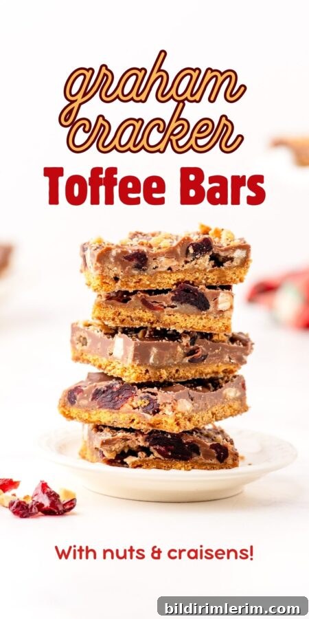 a stack of graham cracker toffee bars with almonds and dried cranberries.