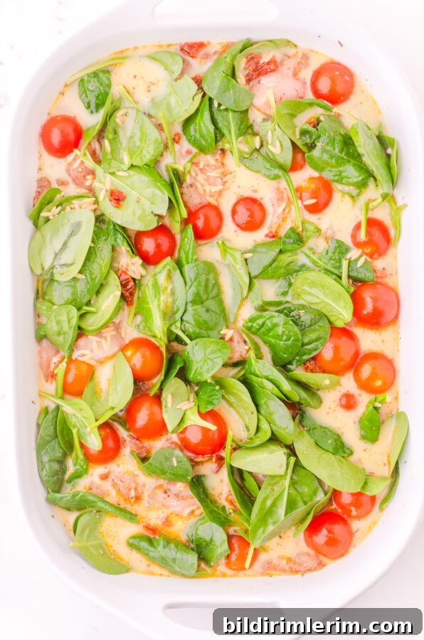 Chicken broth and cream poured over all in a baking pan.