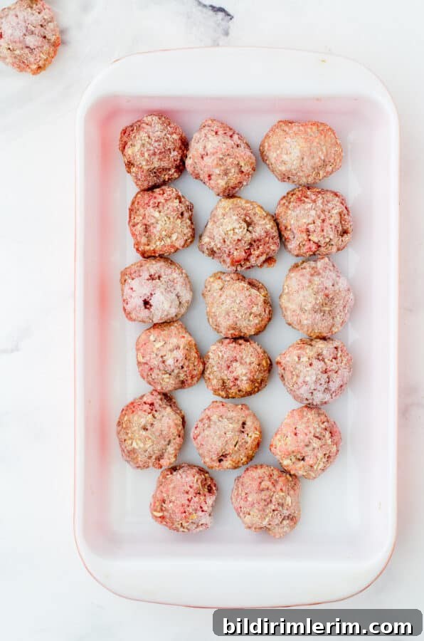 Frozen meatballs in baking dish.