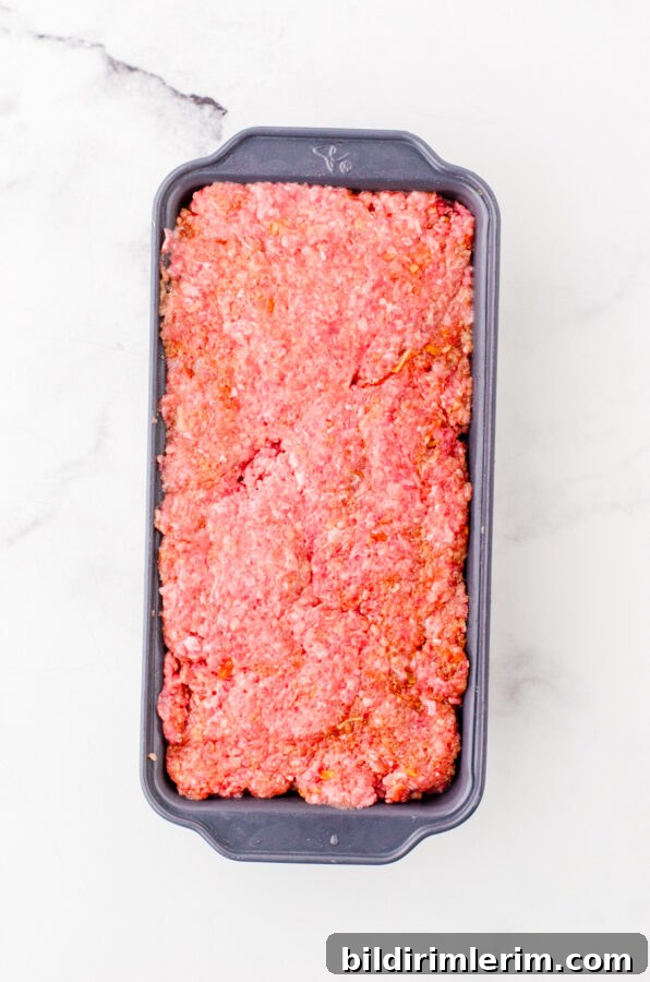 Classic Lipton Onion Soup Meatloaf Recipe for Comforting Dinners 7 Pressed meatloaf mixture in a loaf pan.
