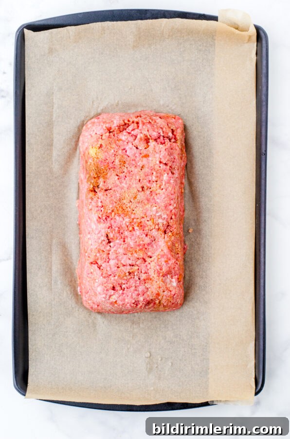 Classic Lipton Onion Soup Meatloaf Recipe for Comforting Dinners 8 Meatloaf popped out of the loaf pan and on a parchment lined rimmed baking pan.