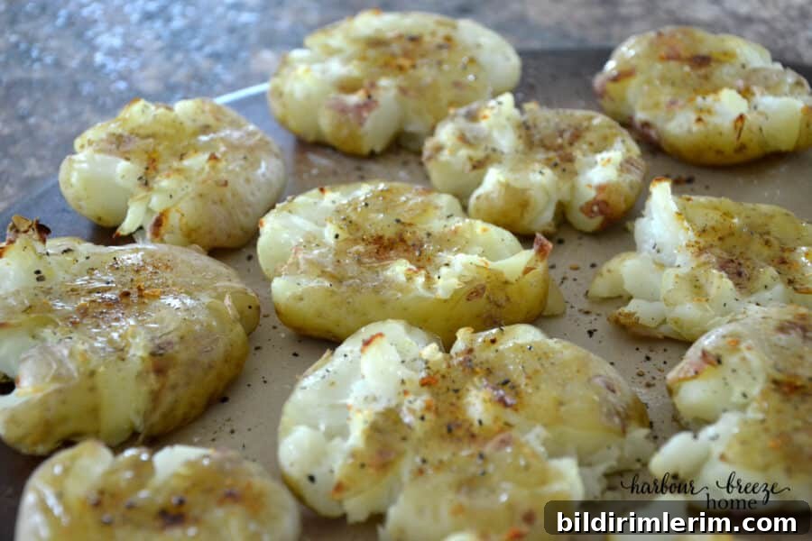 Crispy Smashed Potatoes Recipe with Garlic and Herbs 2 Baked smashed potatoes on a baking tray