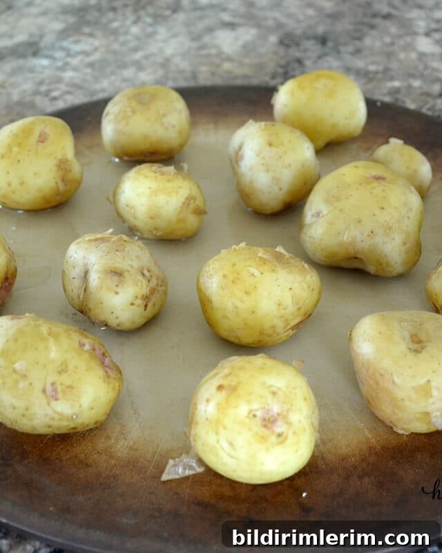 Crispy Smashed Potatoes Recipe with Garlic and Herbs 4 Cooked baby potatoes on a baking pan