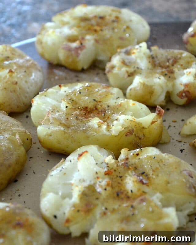 Crispy Smashed Potatoes Recipe with Garlic and Herbs 6 Crispy smashed potatoes on a baking tray