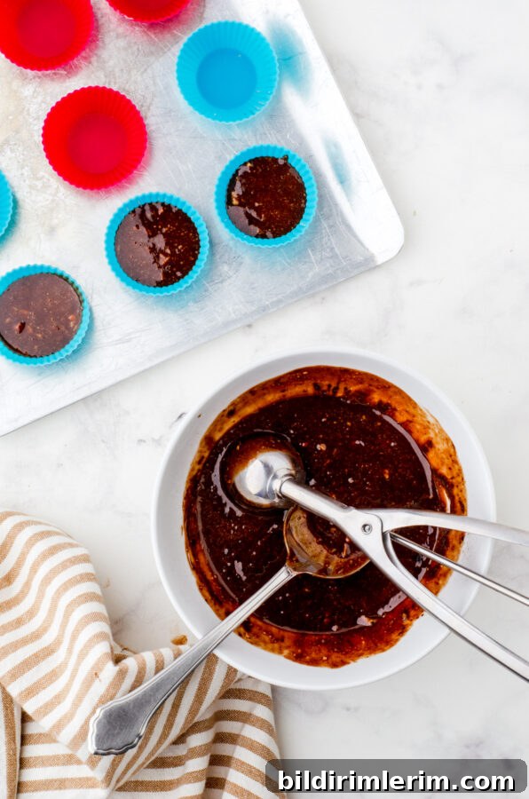Scooping mixture into silicone muffin cups