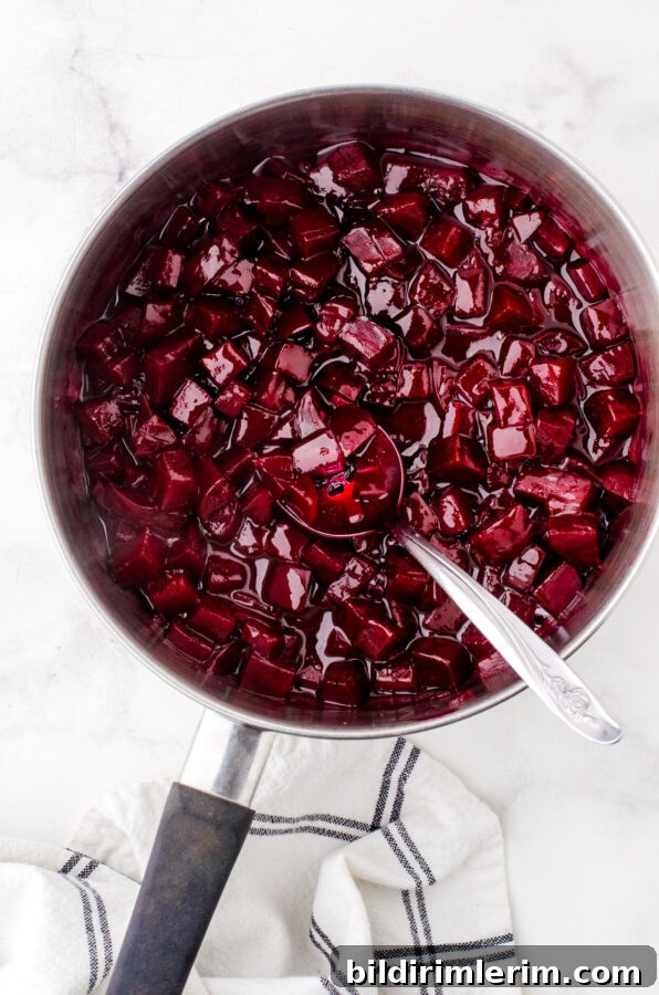 Cooked harvard beets in a saucepan.