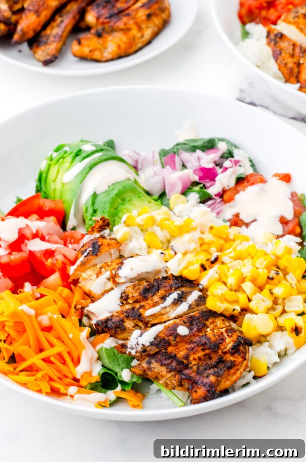 Build Your Own Mexican Chicken Rice Bowls Recipe 5 a mexican chicken rice bowl with sauce drizzled over the top