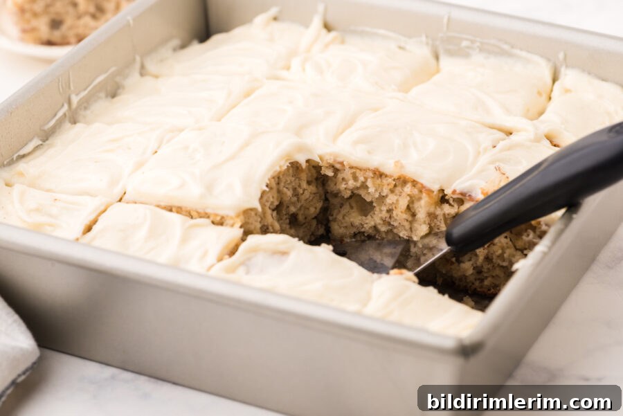 Banana cake in an 8x8 pan with cream cheese icing