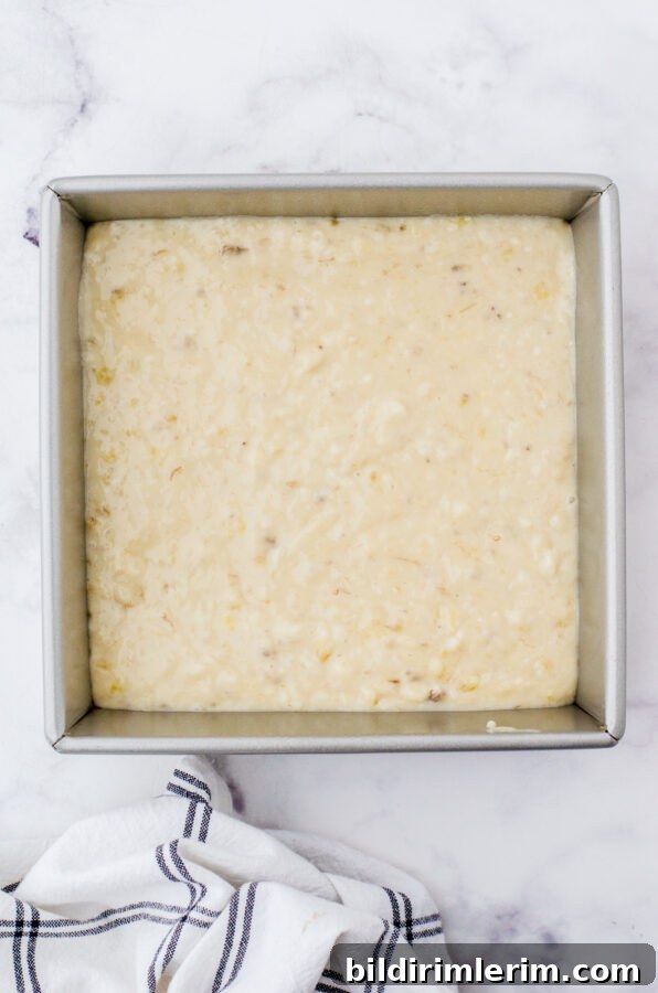 Banana cake batter poured into an 8x8 pan