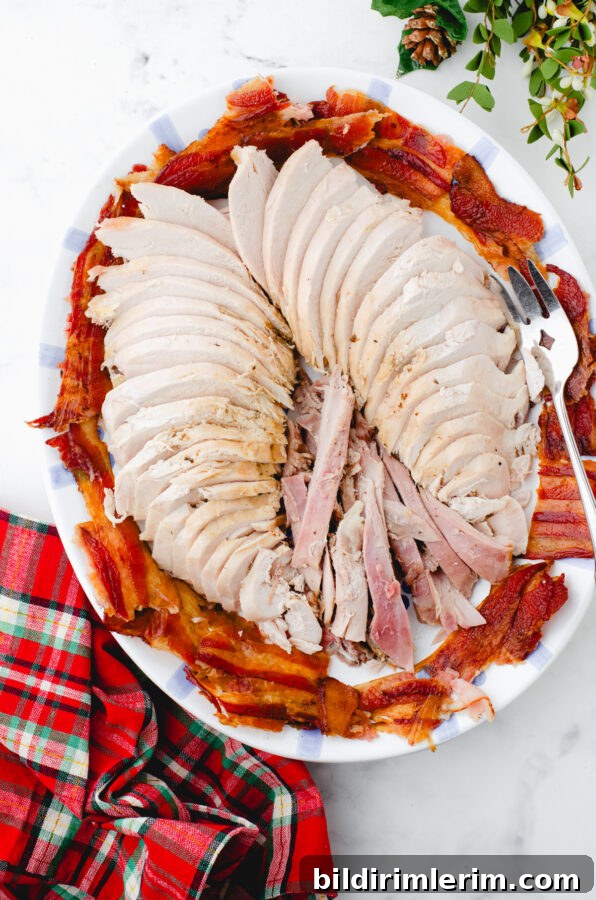 Sliced roasted turkey with bacon garnish