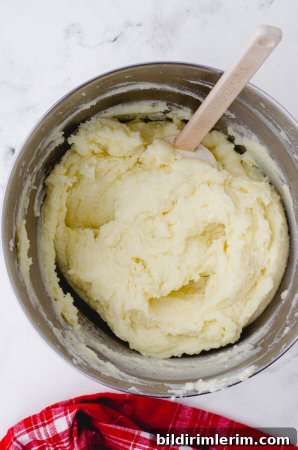 Creamy Whipped Mashed Potatoes with Cottage Cheese 8 Whipped mashed potatoes in a mixing bowl