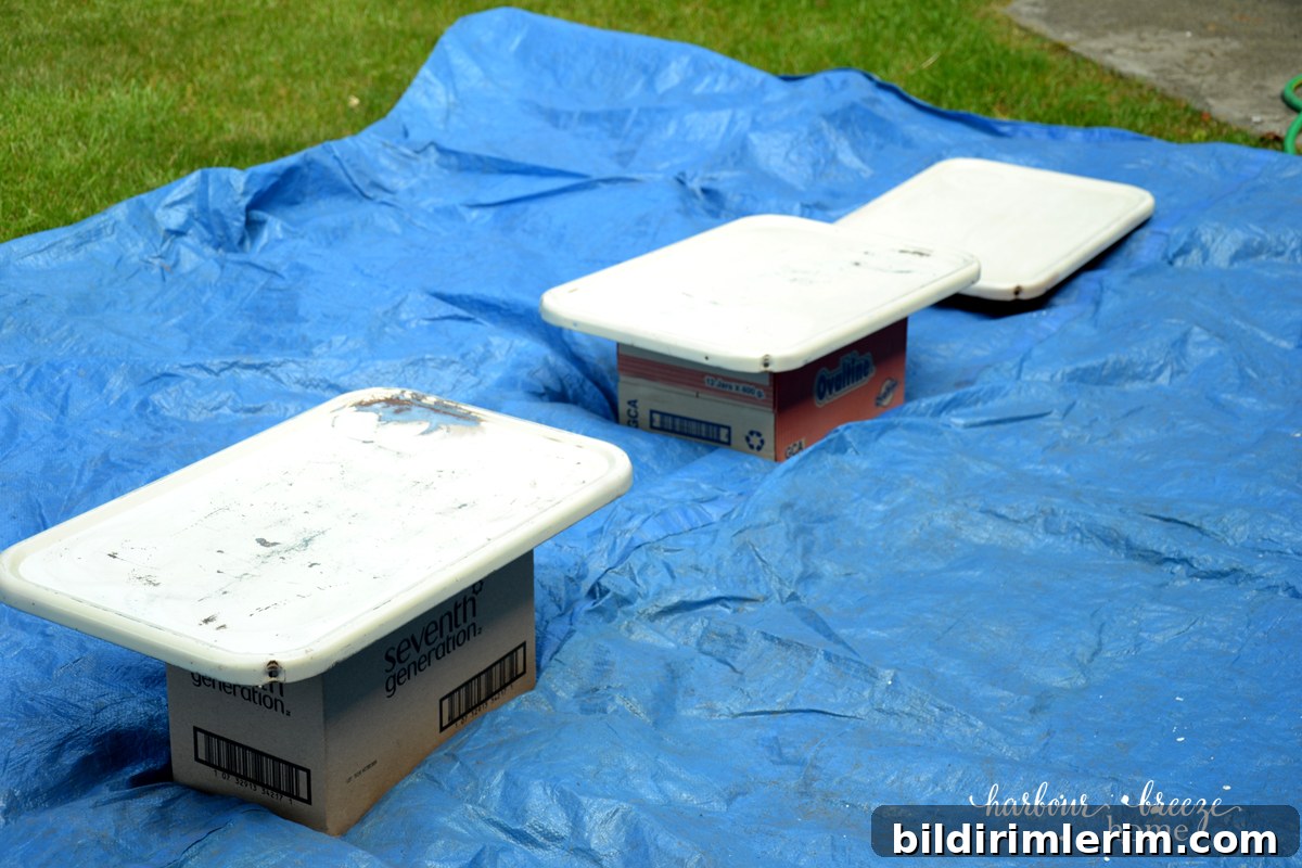 DIY Paint Rusty Metal: Weekend Vintage Cart Makeover 3 spray painting metal ~ 3 metal trays from a 3 tier rolling metal cart laid out on a tarp