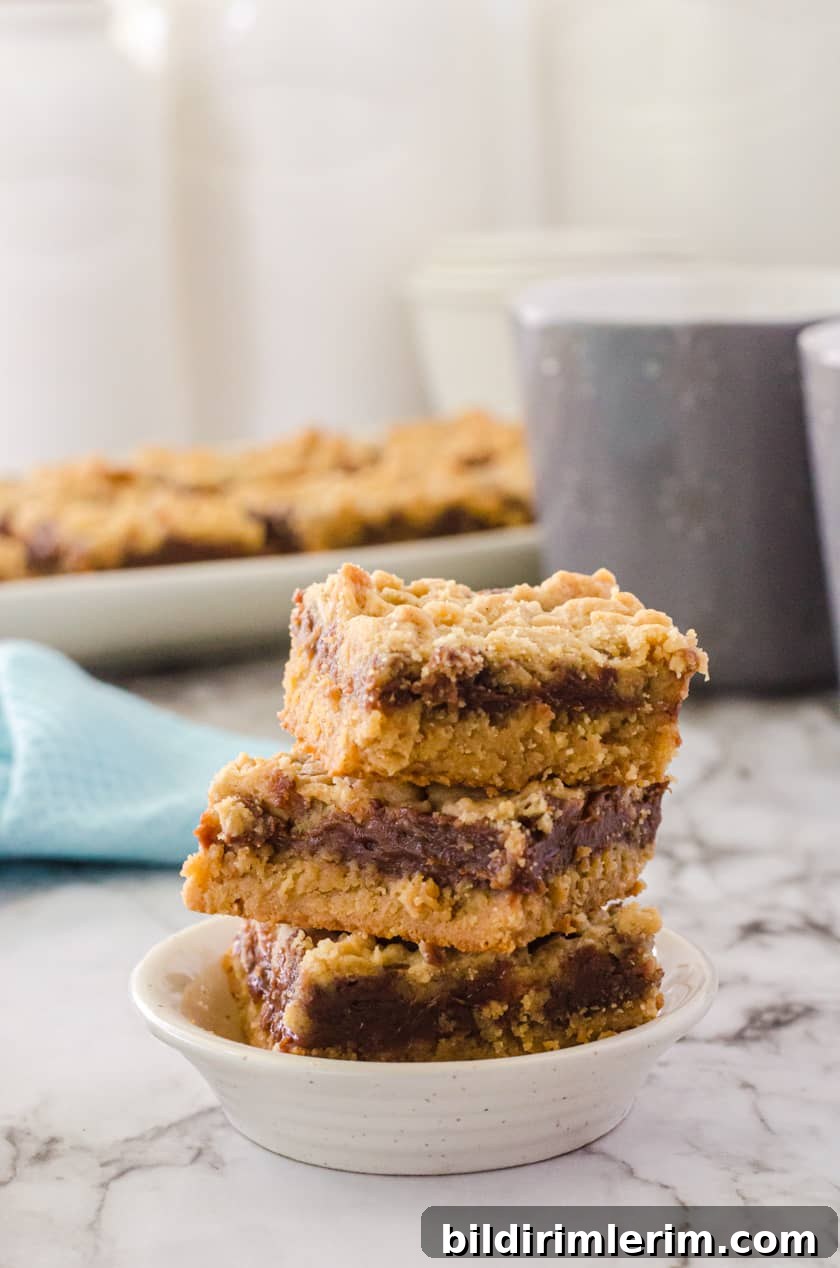 Three peanut butter fudge bars stacked up