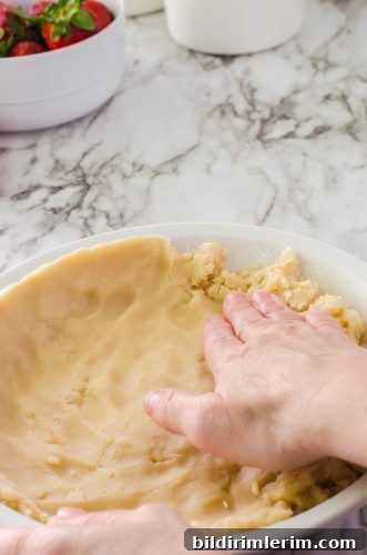 Strawberry Jello Pie Recipe with Grandma's No-Roll Crust 6 Pie crust being patted into a pie pan