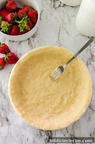 Strawberry Jello Pie Recipe with Grandma's No-Roll Crust 7 pie crust being pricked with a fork