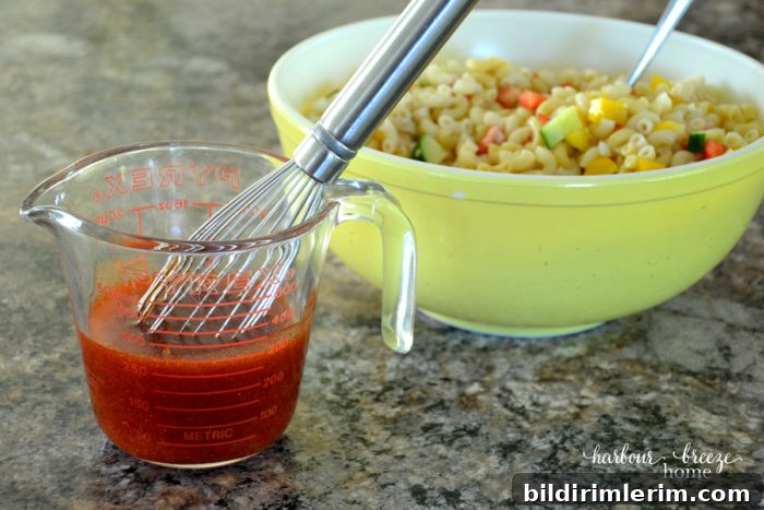 Macaroni Salad with Tangy Ketchup Dressing 6 pasta salad ketchup dressing in a measuring cup with a whisk