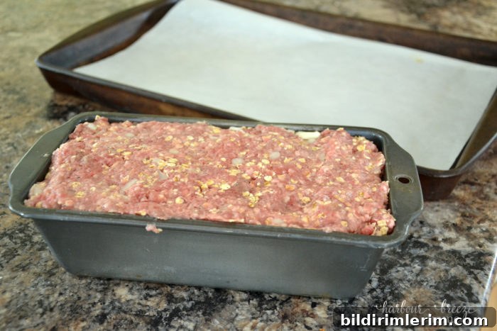 Meatloaf mixture pressed into a loaf pan.