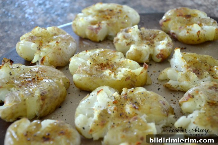 Baked smashed potatoes on a baking sheet.